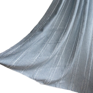 Striped green and blue fabric curtain with geometric embroidery in country style