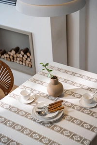 Detailed view of bohemian crochet tablecloth with geometric patterns and fringe edges