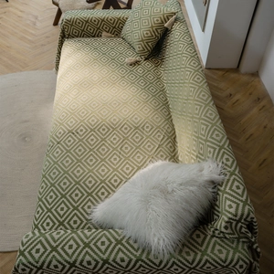 Green and cream bohemian geometric woven sofa cover with matching fringe pillow