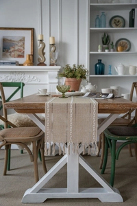 Detailed close-up of Nordic geometric jacquard table runner with white embroidery and tassels