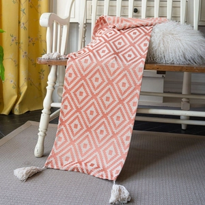 Orange geometric jacquard table runner with white cotton tassels for home decor