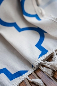 Close-up of bohemian blue geometric pattern curtain fabric with handmade tassels