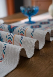 Macro shot of bohemian table runner showing woven texture and geometric triangle patterns