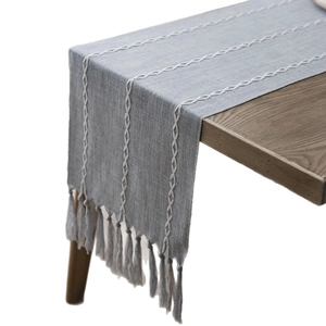 Modern Nordic table runner in grey blue with white woven stripes and elegant tassels