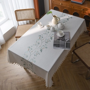 Rectangular cream linen tablecloth with floral embroidery and tassel fringe edges