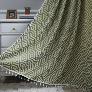 Green and white geometric diamond pattern curtain with elegant tassel fringe decor