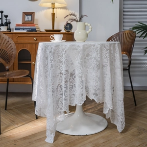 Elegant white lace tablecloth with floral patterns and delicate pearl bead accents