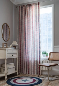 Detail view of cotton linen striped curtains with classic red and blue bohemian patterns