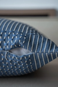 Detail of invisible zipper and woven texture on blue and white decorative pillow cover