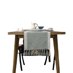 Nordic geometric jacquard table runner with tassels in green and cream woven fabric