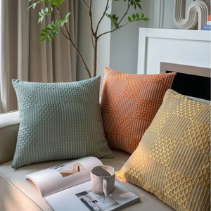 Modern geometric textured throw pillow covers in sage green, terracotta, and mustard colors