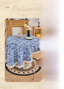 Detail of blue and white jacquard tablecloth with butterfly pattern and white tassels