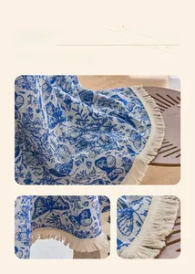 Close-up of vintage blue butterfly jacquard tablecloth with elegant tassel fringe edge