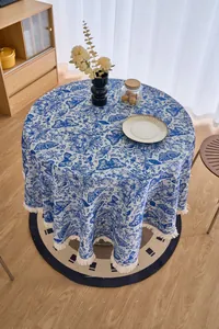Close-up of blue and white jacquard tablecloth featuring butterfly patterns and fringe