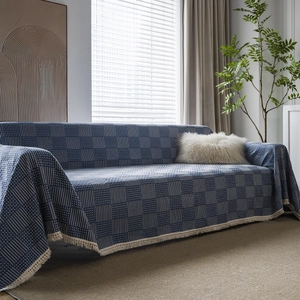 Navy blue geometric jacquard sofa cover with white stripes and elegant cream tassels