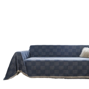 Blue and white geometric jacquard sofa cover with elegant cream lace fringe edges