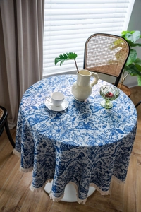 Close-up of blue butterfly floral jacquard tablecloth with elegant cream tassel fringe