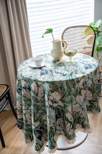 Detailed macro view of the intricate green floral jacquard fabric with elegant cream tassels