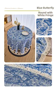 Detail of round floral tablecloth featuring blue butterflies and white tassel fringe