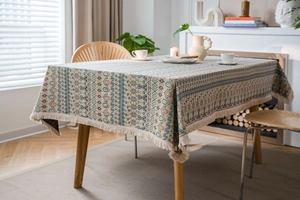 Detailed close-up of Bohemian geometric jacquard tablecloth with white tassel edge decor