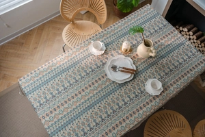 Detail of bohemian geometric jacquard tablecloth with elegant handmade fringe edges