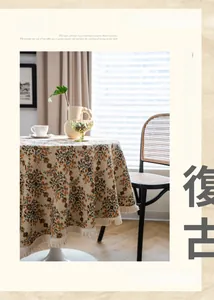 Detail of vintage floral round tablecloth with thick jacquard texture and beige tassels