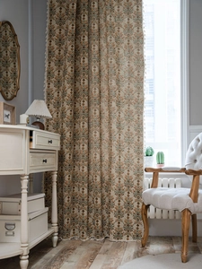 Close-up of vintage floral green jacquard curtain with elegant white decorative tassels
