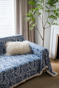 Close-up of blue butterfly floral jacquard sofa throw cover with white decorative fringes
