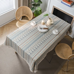 Bohemian geometric jacquard tablecloth with white tassels on a rectangular wooden table
