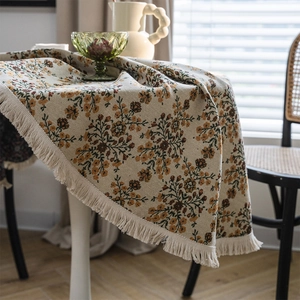 Vintage floral jacquard tablecloth with elegant white tassels for a farmhouse dining room