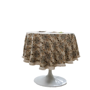 Elegant American jacquard floral round tablecloth with rustic fringe on a minimalist stand