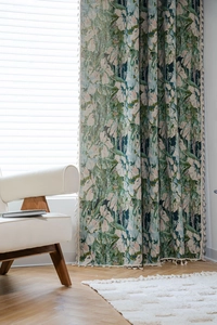 Detailed sage green jacquard curtain fabric with artistic floral patterns and cotton tassels