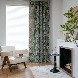 Detail of green floral jacquard curtain with elegant cream tassel fringe trim