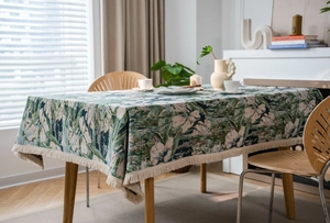 Close-up of bohemian floral jacquard tablecloth with elegant cream fringe tassels