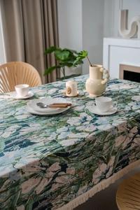 Close-up of bohemian floral jacquard tablecloth texture with retro tassels details