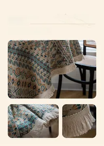 Detail of bohemian geometric tablecloth with cream cotton tassel fringe and textured fabric