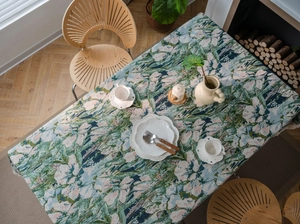 Close-up of bohemian floral jacquard tablecloth texture with woven fringe edges
