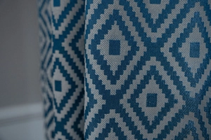 Macro view of blue and white geometric diamond pattern fabric for country style curtains