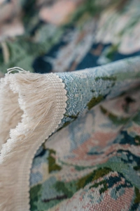 Close-up of floral jacquard weave fabric and fringe edges on a bohemian tablecloth