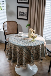 Detailed view of bohemian geometric pattern tablecloth with decorative white fringe edges