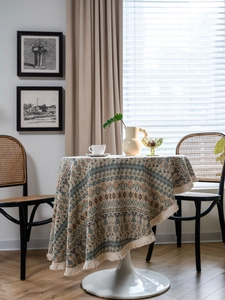 Detail of colorful geometric woven round tablecloth with elegant tassel fringe edges