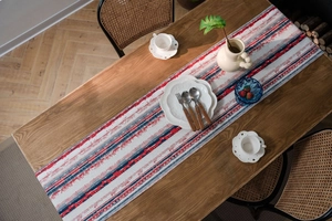 Close-up of ethnic geometric stripes and diamond patterns on woven cotton linen table runner