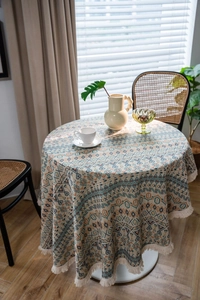 Detailed view of bohemian geometric pattern tablecloth with decorative white tassels