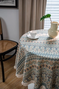 Detailed view of bohemian geometric pattern tablecloth with decorative fringe edge