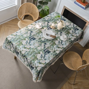 Floral jacquard tablecloth with bohemian tassels shown in a cozy home dining setting