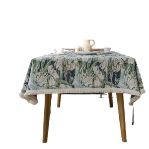 Bohemian floral jacquard tablecloth with fringe tassels on a wooden dining table