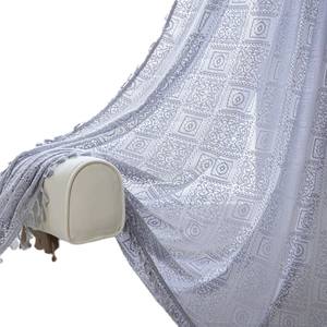 Bohemian style grey crochet curtains with floral geometric patterns and fringe detail