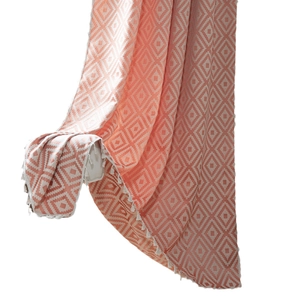 Pink and white geometric diamond pattern curtain with elegant fringe tassels in a clean hanging view