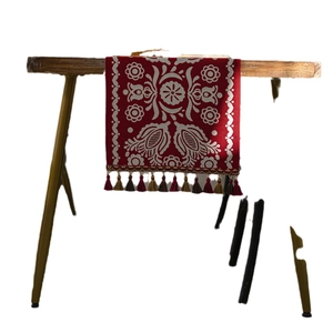 Ethnic style red table runner with white jacquard patterns and colorful tassels
