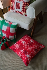 Close-up of festive Christmas cushion cover with wooden button and snowflake print details